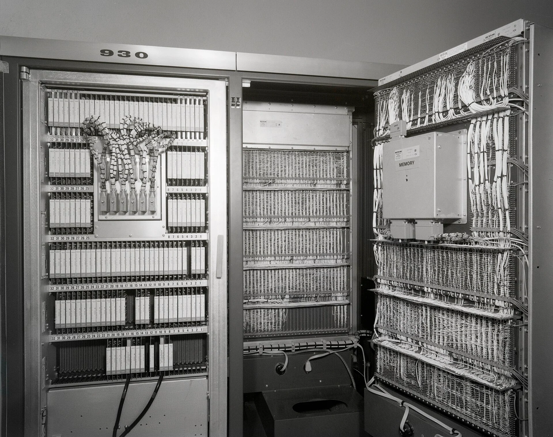 An open Scientific Data Systems 930 cabinet: rows of plug-in circuit cards on the left, hand-woven core memory planes on the right.