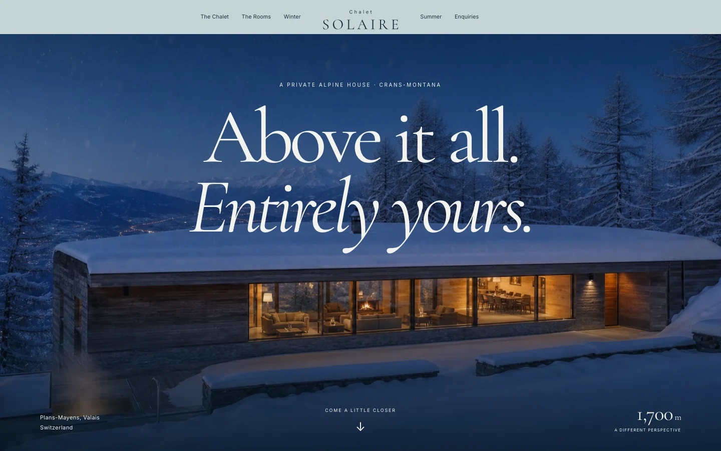 Chalet Solaire: a warmly lit alpine house in the snow.