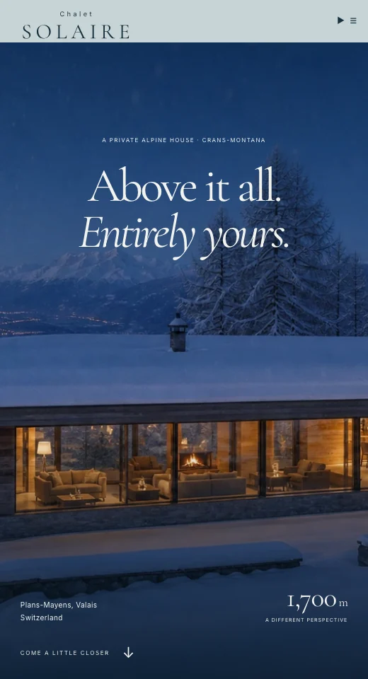 Chalet Solaire: a warmly lit alpine house in the snow.